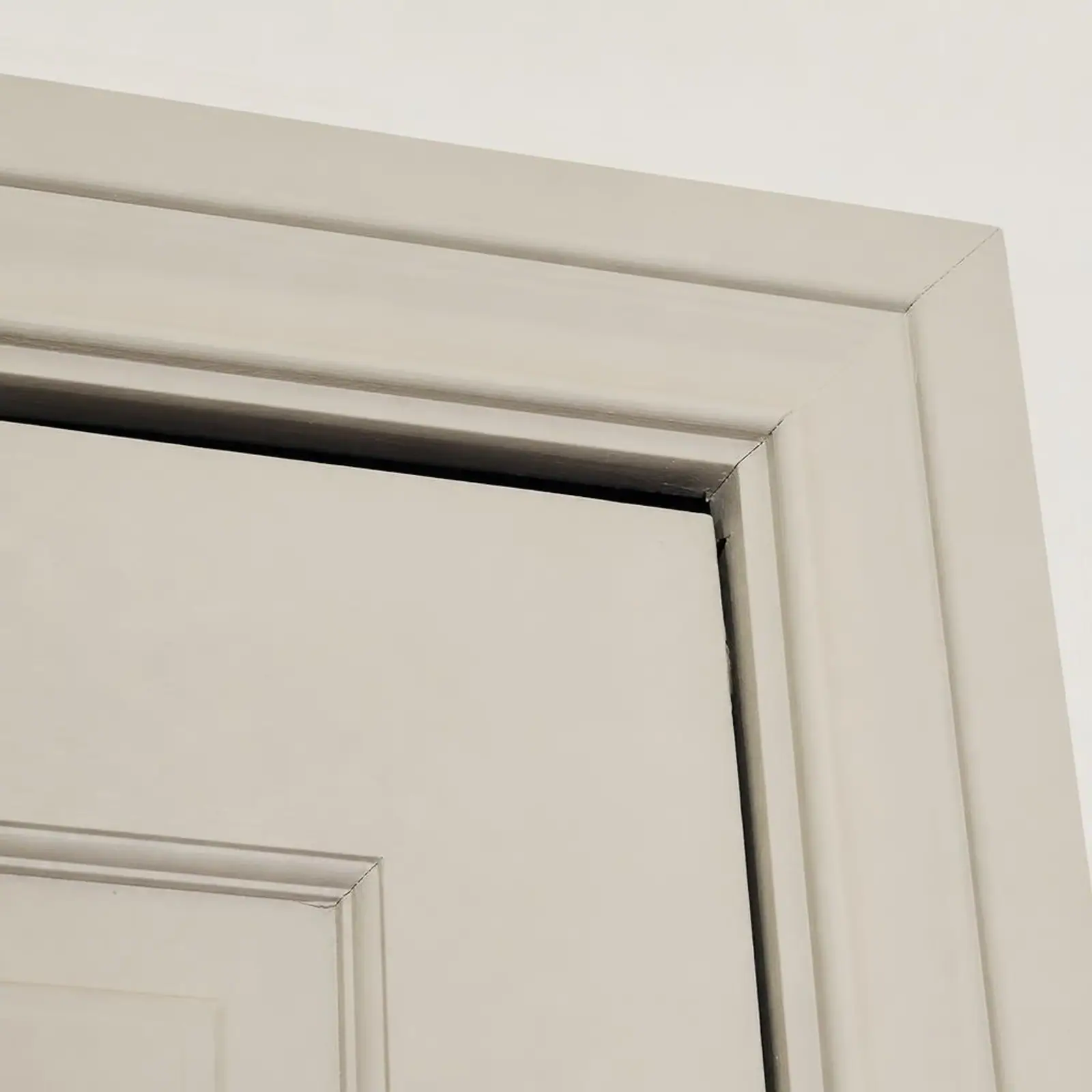 Interior door with an uneven gap along the top edge of the frame